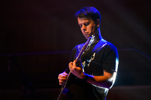 Koncert: 30-lecie S.M.Rock - Scena, występ nauczycieli S.M.Rock - Łukasz Wełna gra na gitarze.