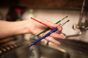 Artystyczne Ferie - tydzień I - Na zdjęciu przedstawione są dzieci uczestniczące w warsztatach plastycznych, skupione na malowaniu i rysowaniu. Widoczne są również osoby prowadzące, które instruują i inspirują młodych uczestników, zachęcając ich do twórczej ekspresji