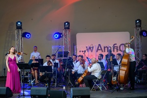 ZDEARZENIA 2024 - Przeboje Wielkiego Ekranu - Na scenie grająca orkiestra Impressione i sopranistka Milena Lange