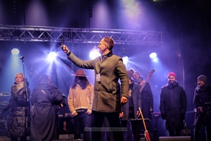 Sylwester na tarnowskim Rynku - Galeria II - Na scenie prezydent Tarnowa Jakub Kwaśny na tle Zespołu Sylwestrowego podczas witania Nowego Roku