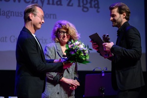 39. TNF: Gala Wręczenia Nagród (7.06.2025) - Na scenie od lewej: jurorzy 39. TNF Łukasz M. Maciejewski i Anna Jadowska wręczający statuetkę Grand Prix - Maszkarona i kwiaty Magnusowi von Horn za film "Dziewczyna z igłą"